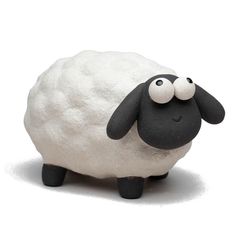 a black and white sheep with two eyes on it's head, standing in front of a white background