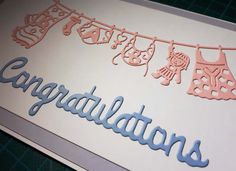 an image of congratulations card with clothes hanging from the line and name cut out on it