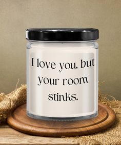 a white jar with the words i love you, but your room stinks