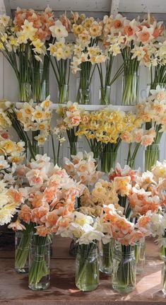 many vases filled with flowers on a table