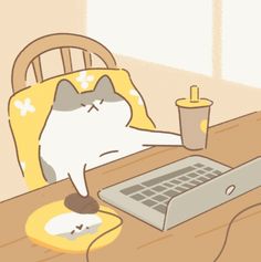 a cat sitting at a table with a laptop