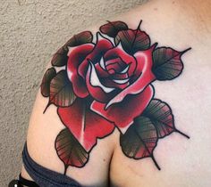 a rose tattoo on the back of a woman's left shoulder and upper arm