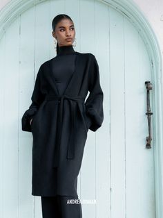 This enveloping Ona Cardigan from Nigerian label Andrea Iyamah is just as soft as it looks. Knitted from an insulating wool blend, it has a flattering longline profile cinched by a matching sash belt at the waist and generous bishop sleeves that add volume. We like it styled with tailored pants and statement heels. Style yours with the label's matching Onyx Ally Knit Pants.- Three-quarter length, narrow placket- Wool blend- Ships from the United States Long Sleeve Outerwear With Tie Waist For Winter, Winter Outerwear With Tie Waist And Long Sleeves, Elegant Wrap Cardigan For Workwear, Fall Daywear Outerwear With Tie Waist, Elegant Wrap Cardigan For Work, Fall Outerwear With Tie Waist For Daywear, Fitted Winter Outerwear With Tie Waist, Chic Merino Wool Outerwear For Work, Belted Cardigan For Fall Workwear