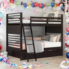 there are two bunk beds with ladders on the floor and balloons in the background