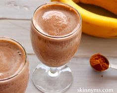 a smoothie in a glass next to some bananas