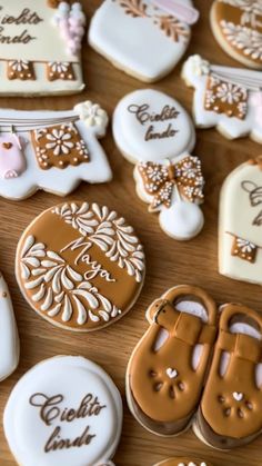 decorated cookies are arranged on a wooden table