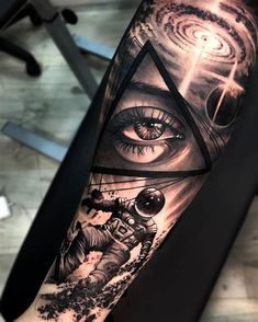 a man's arm with an all seeing eye and astronaut on the space shuttle