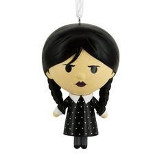 an ornament shaped like a girl with black hair