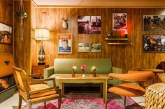 a living room filled with furniture and pictures on the wall