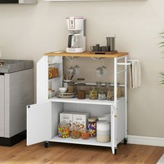 a kitchen with a refrigerator, coffee maker and other items on the shelf in front of it