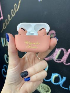 a woman holding an airpods case with the words, will you be there?