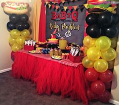 a table topped with lots of balloons and desserts