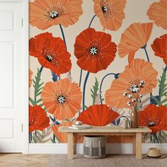 an orange flowered wallpaper in a living room with a wooden table and white door