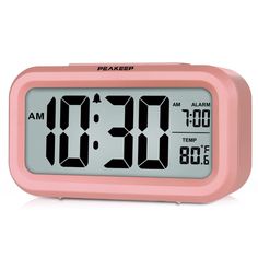 a pink alarm clock with the time at 11 00 pm on it's display