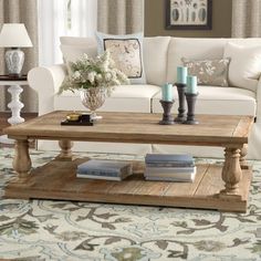 a living room with white couches and a coffee table