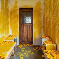 yellow painted walls and benches in front of a wooden door