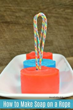 homemade red and blue soap on a rope on a white dish Diy Soap On A Rope, Homemade Soap Recipe, How To Make Soap, Homemade Essential Oils, Make Soap, Soap Making Kits, Homemade Essential Oil, Soap On A Rope, Homemade Scrub