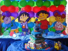 the birthday cake is surrounded by balloons and characters from sesame - o's neighborhood