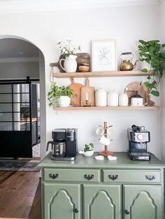 coffee nook with green cabinets and an arched doorway with a black metal and glass sliding barn door Coffee Bar Ideas, Coffee Bar Design, Coffee Bars In Kitchen