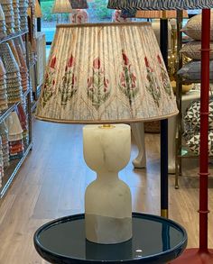 a lamp that is sitting on a table in a store next to a glass table