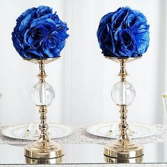 two vases with blue flowers sitting on top of each other