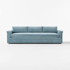 a blue couch sitting on top of a white floor