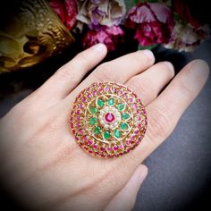 Featuring a large round cocktail ring in 916 hallmark gold set with precious emeralds, rubies and pearls. The ring weighs 16gms and the face diameter is approx 1.7inches. The ring's finger size is adjustable. Price Breakup Summary Component Rupees % of Total 22k Gold 75,504 80.4% Stones & Beads 2,112 2.2% Making Charges 13,591 14.5% Taxes (GST) 2,736 3.0% Total 93,943 100.0% View Detailed Price Breakup Jadau Jwellery, 22k Gold Jewelry Necklaces, 22k Gold Jewelry, Pearl Necklace Set, Gold Jewelry Necklace, Emerald Necklace, Gold Bangle Bracelet, Gold Set, Precious Gemstones