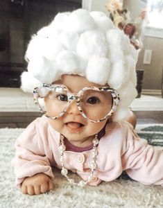 a baby wearing glasses and a white wig