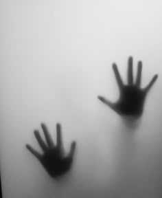 two hands are seen through the fog in this black and white photo