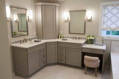 a large bathroom with two sinks and mirrors