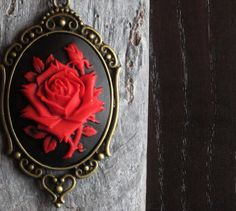 Beautiful red cameo with a dimensional rose on a black background set in antique brass paired with antique brass chain. Details: Pendant measures approx 2.5 inches in length Necklace measures 24 inches Setting and chain are plated brass Cameo is hard, matte resin Want a shorter chain? Just leave a note to seller at checkout for me and I can adjust it for you, no extra charge. Thank you for shopping Delicate Industry :) Marine City, Necklace Gothic, Gothic Necklace, Cameo Jewelry, Necklace Flower, Length Necklace, Holiday Gift Ideas, Necklace Red, Cameo Necklace