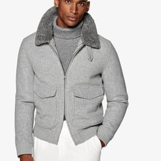 This light grey bomber jacket is tailored to a comfortable regular fit with a hip length and features double end opening zip closure, detachable shearling collar, flapped patch pockets, and ribbed hem and cuffs for a tapered finish. Gray Winter Outerwear With Zip Fly, Gray Long Sleeve Outerwear With Ribbed Collar, Fitted Collared Outerwear With Ribbed Cuffs, Fitted Winter Outerwear With Fold Down Collar, Fitted Outerwear With Fold Down Collar For Winter, Gray Outerwear With Ribbed Cuffs For Work, Gray Ribbed Cuffs Outerwear For Work, Gray Workwear Outerwear With Ribbed Cuffs, Gray Wool Outerwear With Ribbed Cuffs