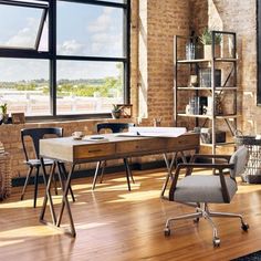 a room with a desk, chair and bookshelf next to a large window