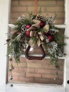 a christmas wreath hanging on the front door