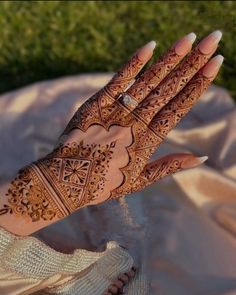 a woman's hand with hennap on it, showing the intricate design