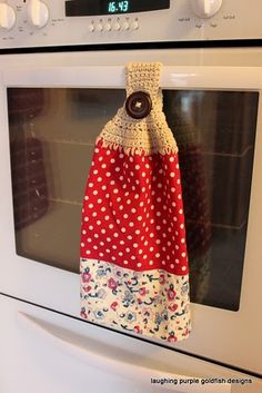 an oven mitt is hanging on the front door of a white stove top oven