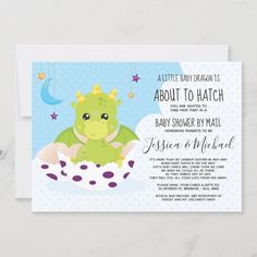 a baby shower card with a green dragon sitting on top of a white cloud in the sky