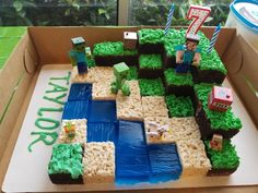 a cake made to look like a mineo field with grass and blocks on it