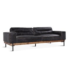 a black leather couch sitting on top of a wooden frame