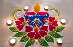 a decorated diya with candles on the floor