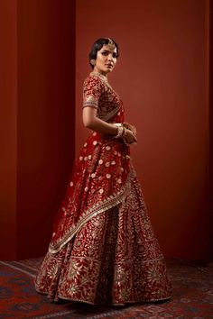 Heavy Red Lehenga Bridal in Thread Embroidery is emblazoned in Swarovski crystals and paired with a magnificent red lehenga/gharara in velvet decorated with minute thread details and a heavily embroidered dupatta. Choli: This heavy bridal lehenga comes in thread embroidery in white color with red velvet base and heavily embellished neckline and heavily embroidered sleeve, finished with a side zip closure. Lehenga: It is paired with a trailed self-jamavar lehnga, heavily embellished around its flare. Pakistani Red Lehenga Bridal Choli is paired with sequins, thread, and tilla print embellishments that are a perfect choice to wear on a big day. The perfect combo of white and red creates a Dreamy Bridal Attire for your Wedding Day. Dupatta: This beautiful Red Velvet base Lehenga Choli sets a Red Choli With Meenakari And Kundan, Red Meenakari Anarkali Set For Wedding, Red Bollywood Lehenga With Meenakari Details, Bollywood Red Sharara With Meenakari, Anarkali Style Red Meenakari Choli, Red Semi-stitched Meenakari Lehenga, Red Meenakari Anarkali Choli, Red Meenakari Sharara For Wedding, Red Meenakari Sharara For Festivals