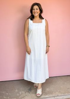 Get ready for summer with our Sea Worthy Linen Midi Dress! Effortlessly stylish with stripes and ric rac trim, this lightweight dress is perfect for vacations and beach days. Sun, sand, and style all in one piece! True to size Piper is wearing large Color: White with black pin stripes Stripe print square neck sleeveless midi dress featuring ric rac trim. Pocket at sides. Lined. Woven. Non-sheer. Lightweight. Fabric: 55%COTTON 35%LINEN 10%POLYESTER Fabric has no stretch Pull on design Striped Maxi Dress With Vertical Stripes For The Beach, Beach White Maxi Dress With Vertical Stripes, Striped Maxi Dress For The Beach, Summer White Dress With Vertical Stripes, Striped Beach Maxi Dress, Lined, Striped Cotton Sundress For The Beach, Striped Lined Maxi Dress For Beach, Striped Lined Maxi Dress For The Beach, Striped Lined Beach Dresses