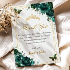 a thank you card with green flowers and gold trimmings on a white sheet