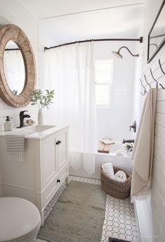 a bathroom with a sink, toilet and mirror