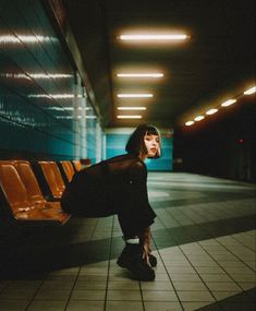 a woman sitting on a bench in an airport