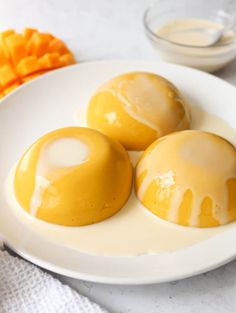 three orange desserts on a white plate