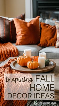 a living room with pumpkins and candles on the coffee table in front of a couch