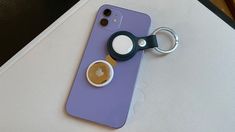 a purple iphone case with a pair of scissors on it and a cup of coffee