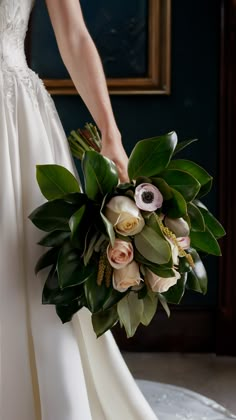 a bride holding a bouquet of flowers in her hand