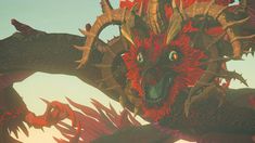 a red and black dragon with horns on it's head